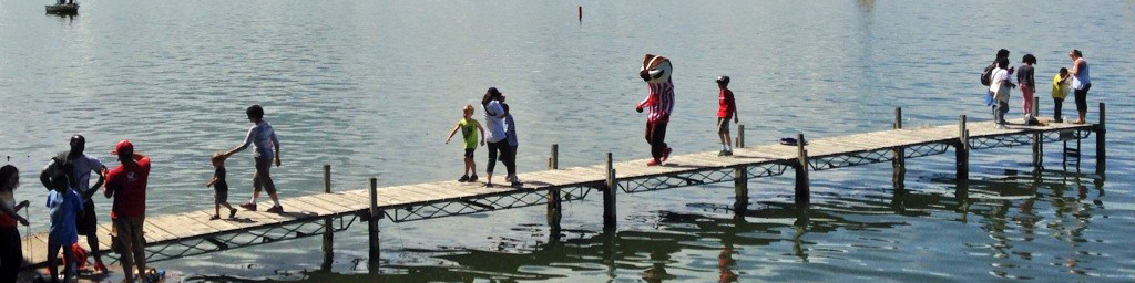 Photo of Bucky Badger and children walking on Hasler Lab dock during Open House