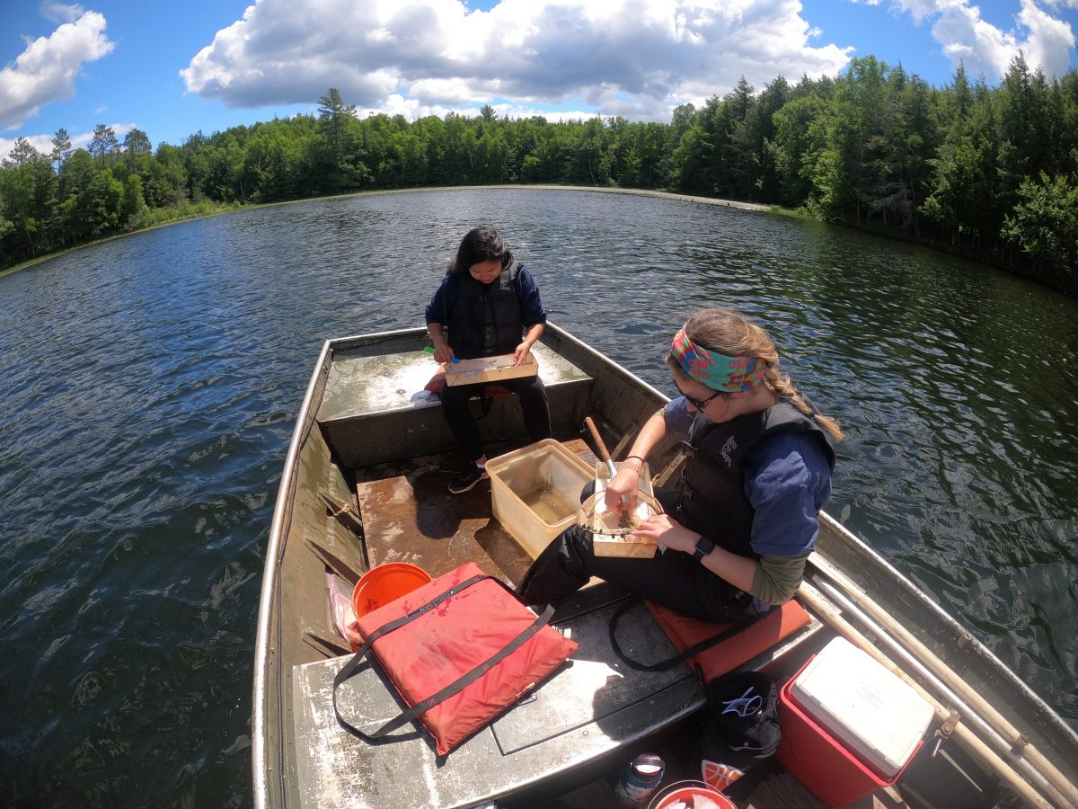 two people doing field work in boat
