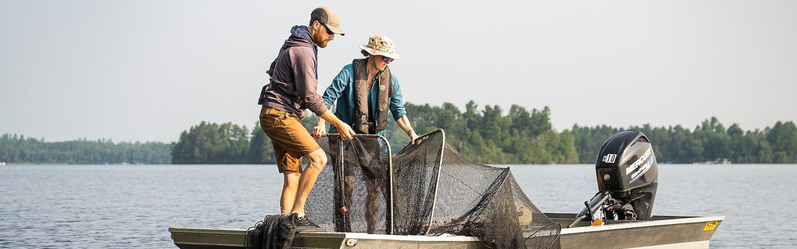 Carol Warden, researcher with the Center for Limnology at UW–Madison and the Trout Lake Research Station, collects data on fish type, size and weight in Trout Lake as part of a Long-Term Ecological Research (LTER) study. She is joined by Paul Schramm (left), another UW–Madison Center for Limnology scientist, during the sampling process.