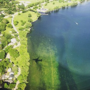 Image of shadow of airplane flying over lake