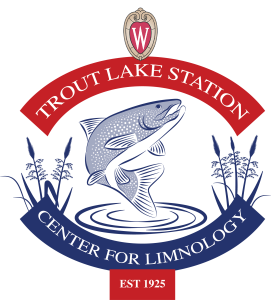 Trout Lake Station logo with drawing of a trout jumping out of water in the center and drawing of wild rice on left and right of fish. Words Trout Lake Station arching at top and Center for Limnology arching at bottom.