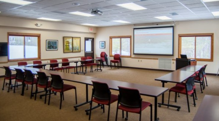 Tug Juday Conf Room at TLS showing space, windows, tables, chairs, AV equipment